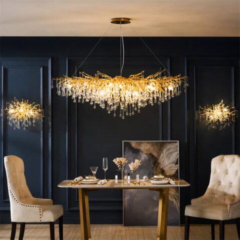 Araña de cocina larga y dorada con diseño de lágrimas sobre fondo azul oscuro con mesa y sillones