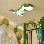 Araña de metal con forma de dinosaurio infantil en el techo de un dormitorio beige